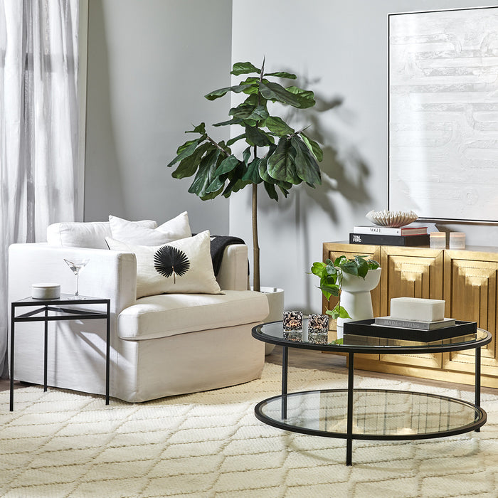 Modern living room with [Brand] furniture, houseplants, and artwork.