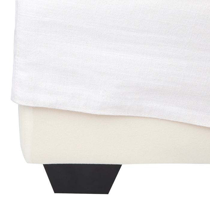 [Brand] bed featuring white fabric skirt and black leg.