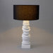 Elegant [Brand] lamp with black shade and sculpted base.