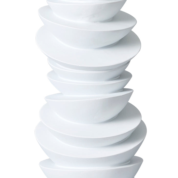 Stacked white bowls from [Brand], uniquely slanted and modern.