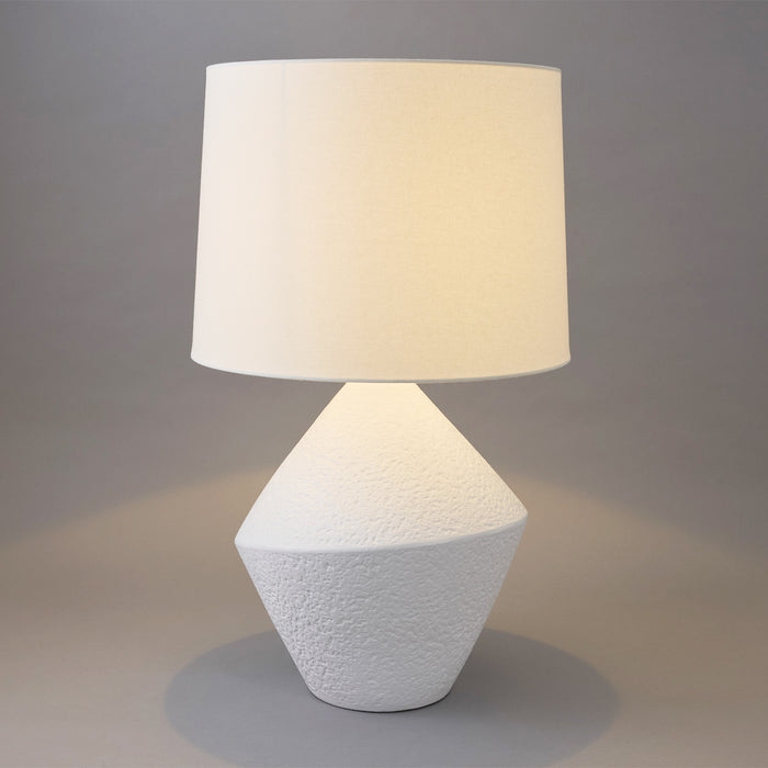 A [Brand] table lamp with a textured white base.