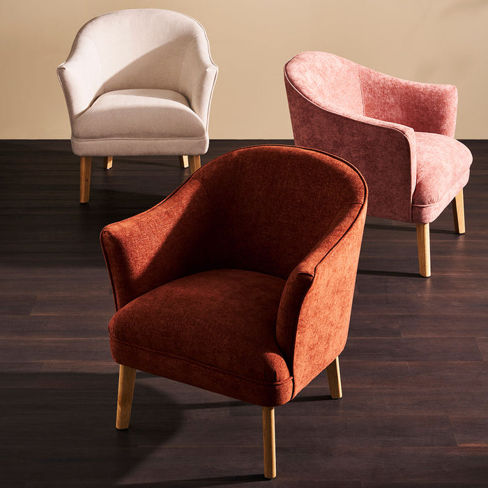 Three elegant [Brand] armchairs in cream, pink, and orange.