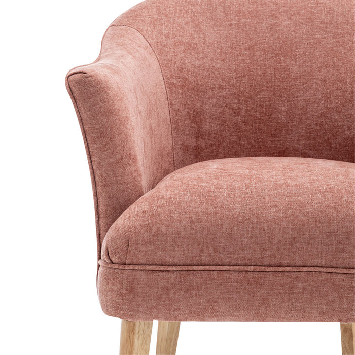 [Brand] pink fabric chair with natural wooden legs, close-up.