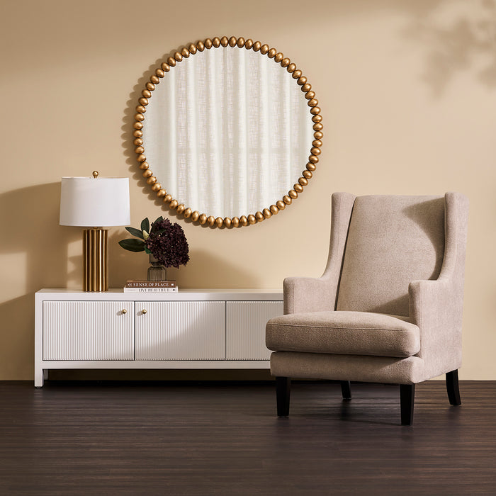 [Brand] room with armchair, round mirror, lamp, and console.