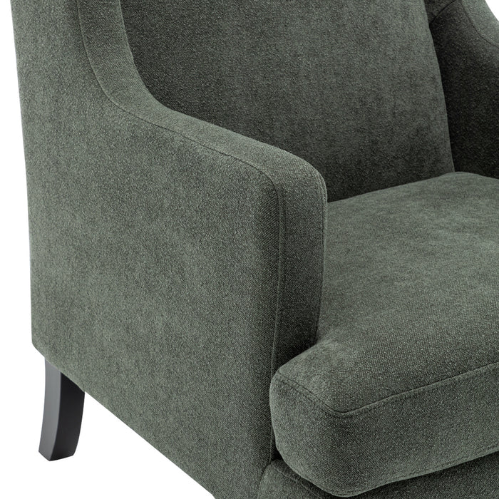 Green upholstered armchair from [Brand] with wooden legs, detailed texture.