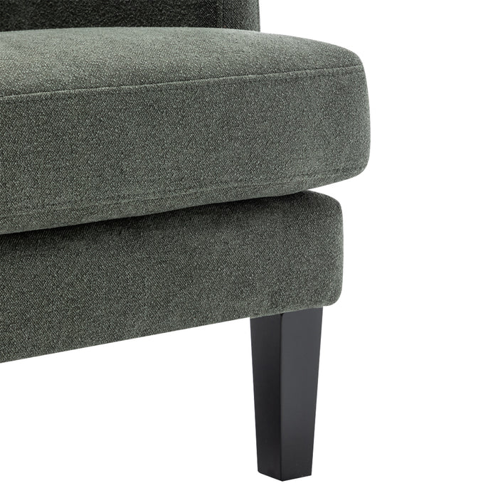 Close-up of [Brand] green upholstered chair with black legs.