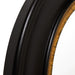 Close-up of [Brand] black and gold circular mirror frame.
