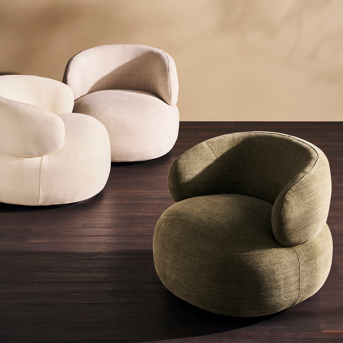 Three modern [Brand] chairs on dark wooden floor.