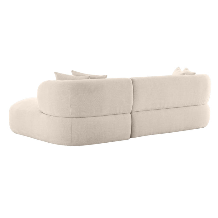Beige fabric sofa with curved design, cushions, from [Brand].