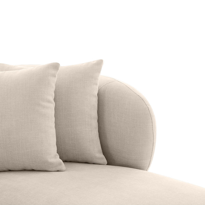 Two beige [Brand] cushions on a comfortable fabric sofa.