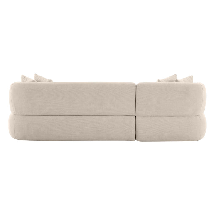 [Brand] beige sofa viewed from the back, with pillows.
