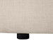 [Brand] beige textured fabric with black circular wooden leg.