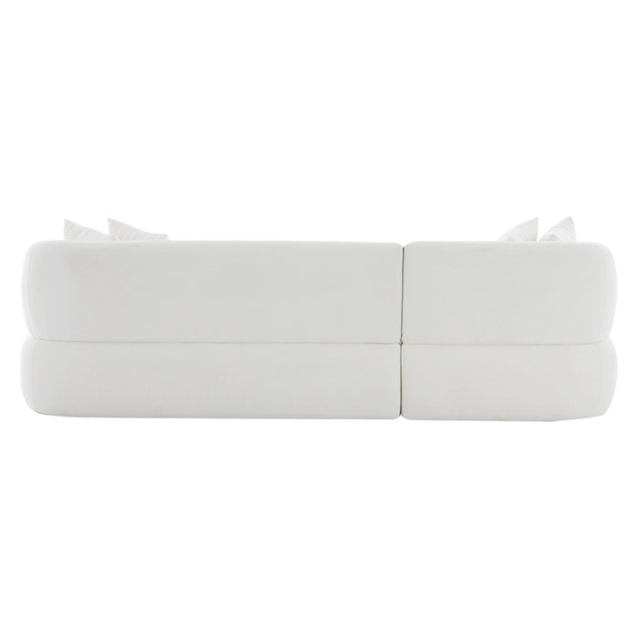 [Brand] modern white sofa with cushions, viewed from rear.