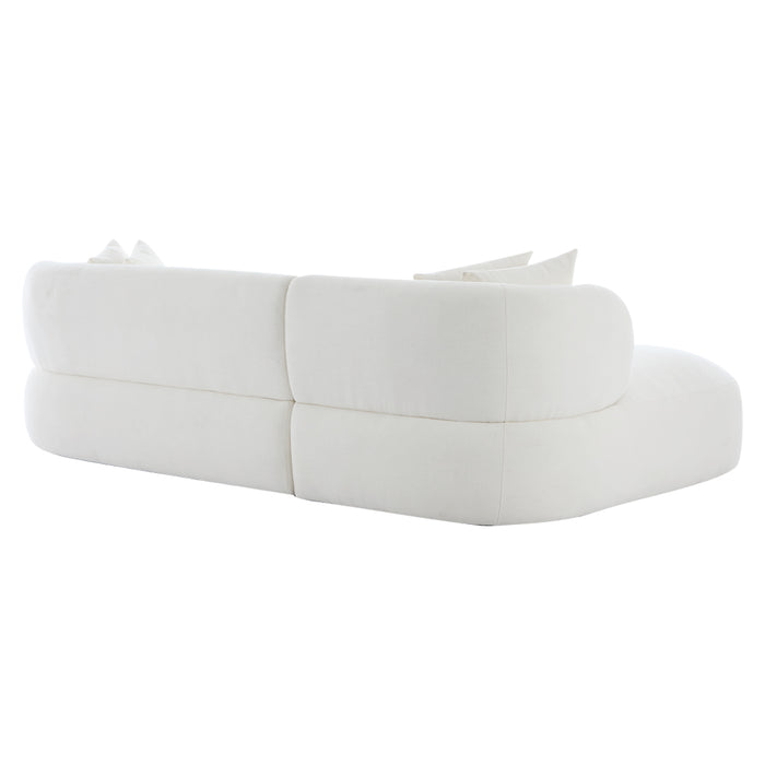 White curved sofa with cushions, rear view, [Brand] design.