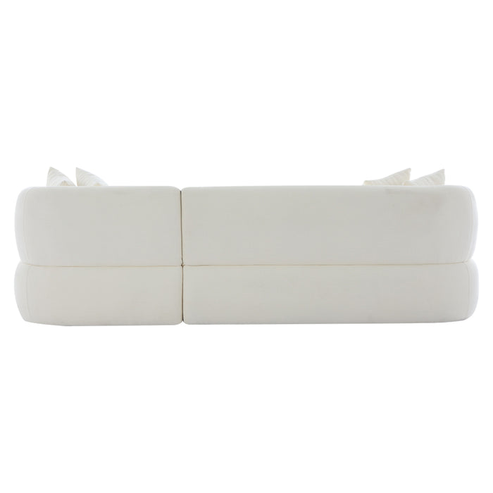 White [Brand] sofa with plush cushions, seen from behind.