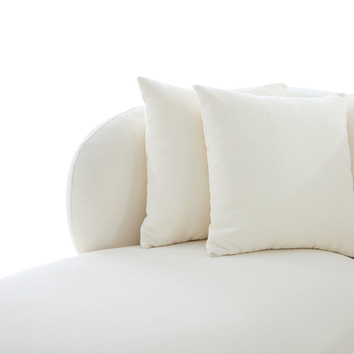 Cream [Brand] sofa with two matching decorative pillows.