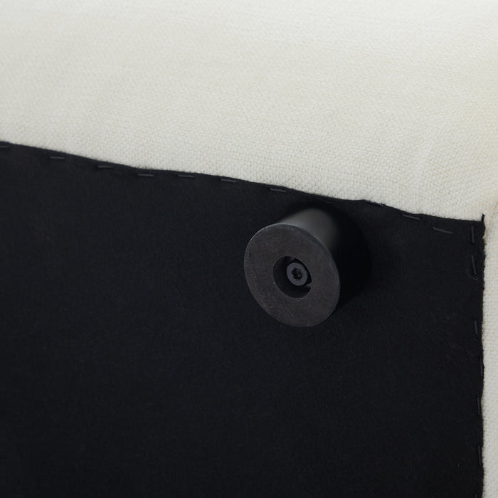 Close-up of [Brand] furniture's black leg and white fabric.