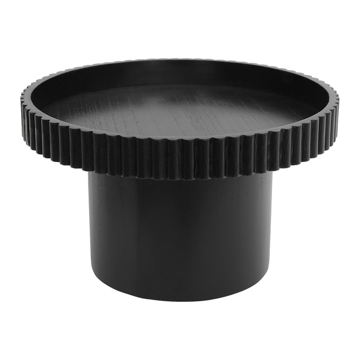 Black round [Brand] table with ribbed edges and cylindrical base.