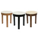 Three [Brand] round side tables in different wood finishes.