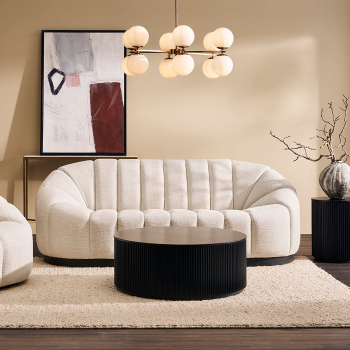 [Brand] elegant modern living room with plush cream sofa.