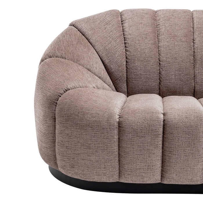 Plush beige sofa by [Brand] with vertical tufted design.