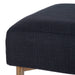 [Brand] black textured ottoman corner with wooden leg detail.