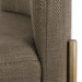 [Brand] chair with textured fabric and brass metallic accent.