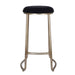 [Brand] stool with black cushioned seat, elegant brass legs.