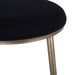 [Brand] chair with black cushion, gold metallic legs detail.