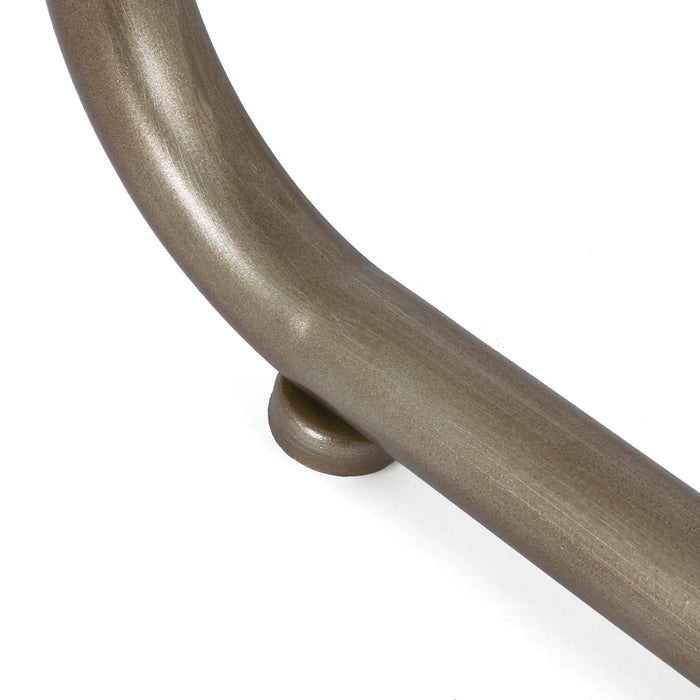 Curved bronze [Brand] handle detail on white background surface.