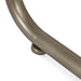 Curved bronze [Brand] handle detail on white background surface.