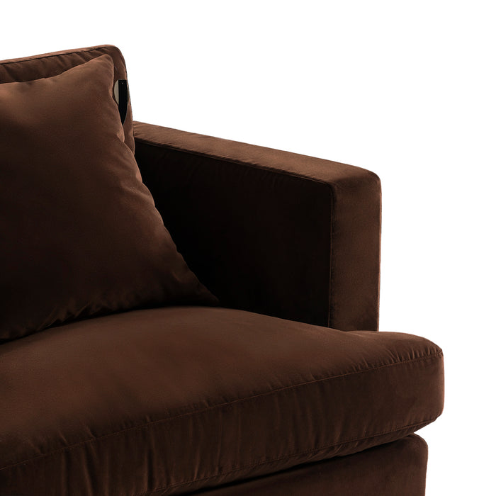 Brown plush sofa arm and cushion by [Brand], close-up.