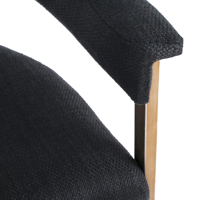[Brand] chair with black textured upholstery and wooden armrest.