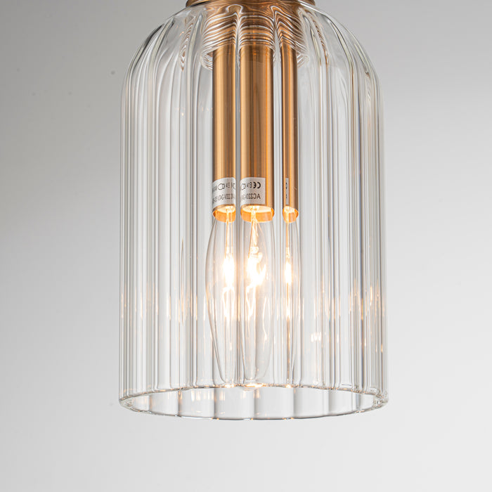 [Brand] pendant light with clear glass and gold accents.