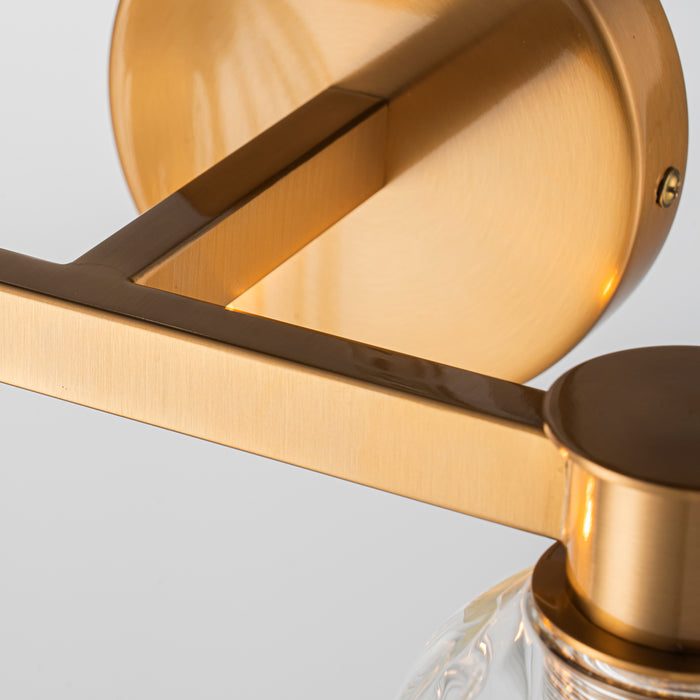 [Brand] gold wall light fixture with sleek, modern design.