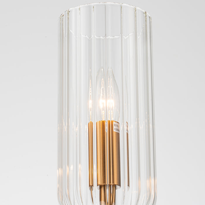 Glass lamp with gold accents, illuminated by [Brand] bulb.
