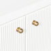 [Brand] white cabinet with gold knobs and vertical grooves.