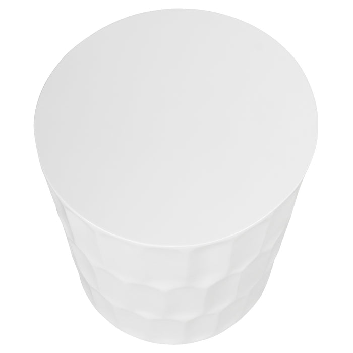 White, cylindrical [Brand] table with textured geometric surface design.