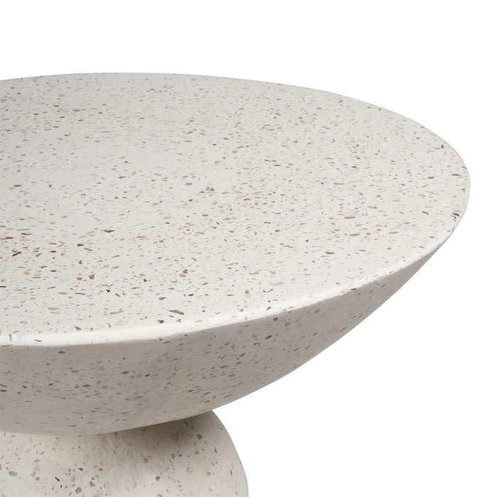 Terrazzo round table from [Brand] with speckled design, side view.