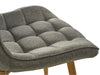 Gray tufted chair seat with wooden legs, [Brand] design.