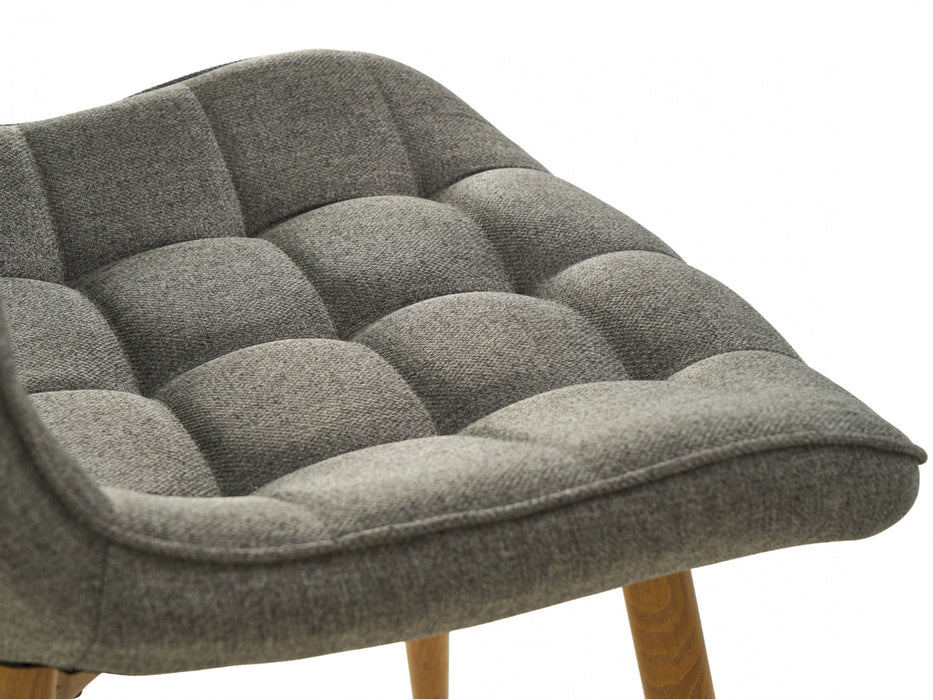 Gray tufted chair seat with wooden legs, [Brand] design.