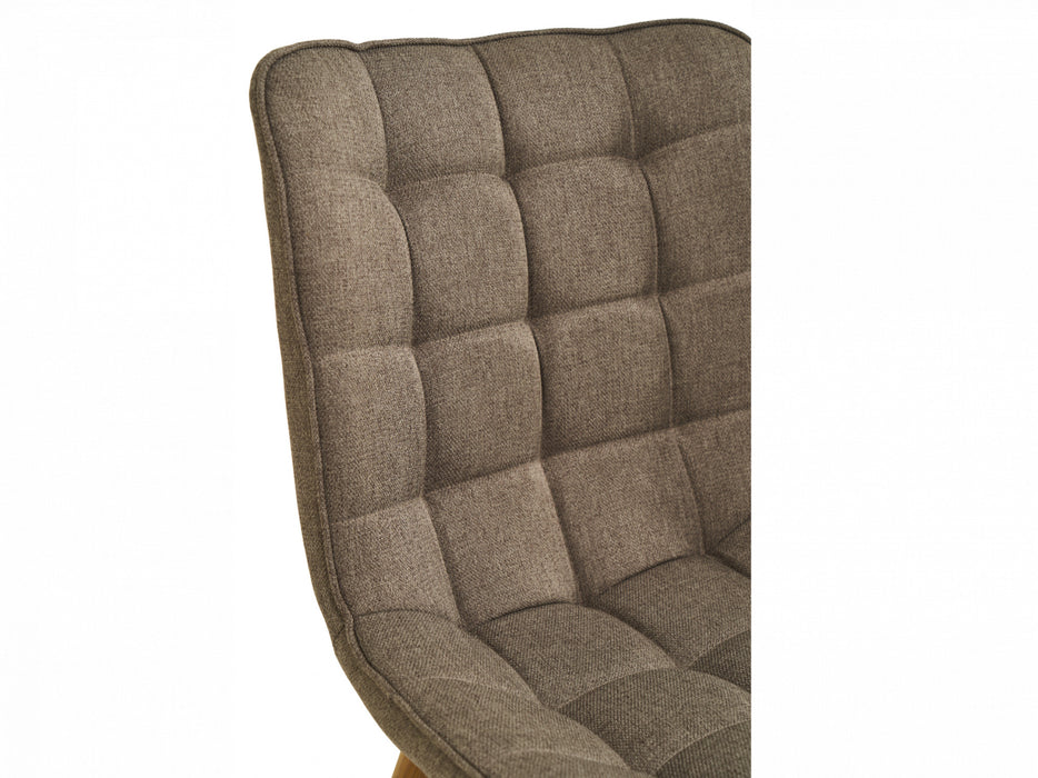 Close-up of [Brand] chair, featuring tufted brown fabric upholstery.