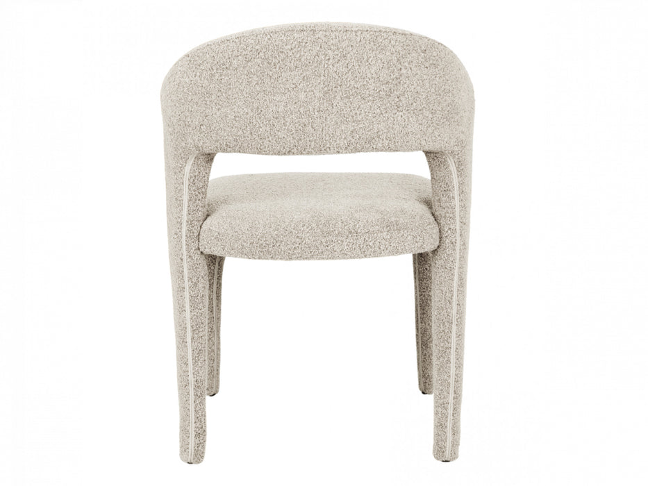 A plush chair with rounded back by [Brand], beige-colored.