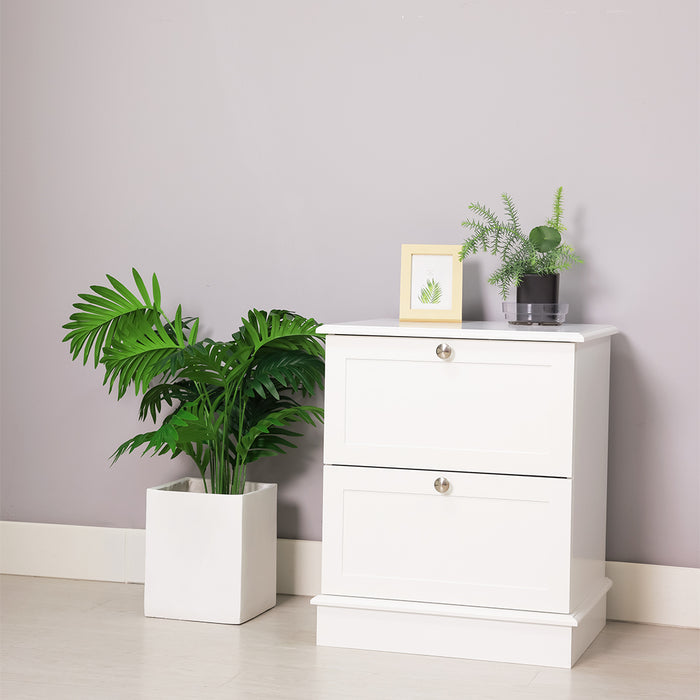 White [Brand] cabinet with plants and decorative frame, minimalist setting.