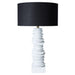 [Brand] sculptural white table lamp with black lampshade.