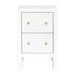 [Brand] white nightstand with two drawers and gold knobs.