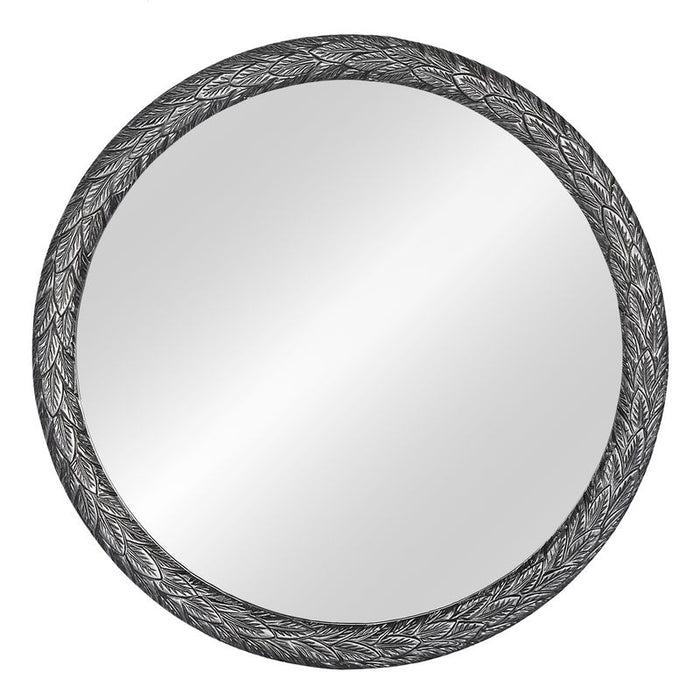 Round mirror with detailed leaf-patterned frame by [Brand].
