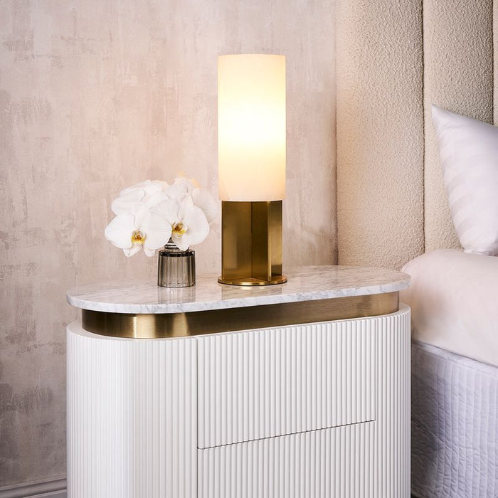 [Brand] bedside table with lamp, orchids, marble top.